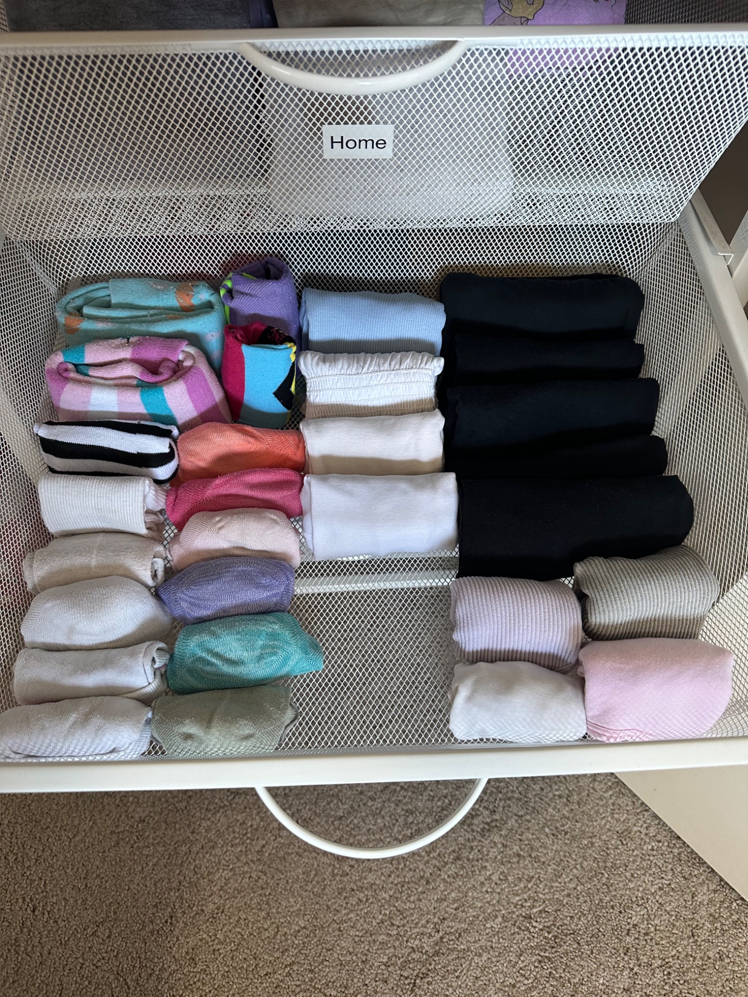 Clothes folded visibly in an open wardrobe drawer